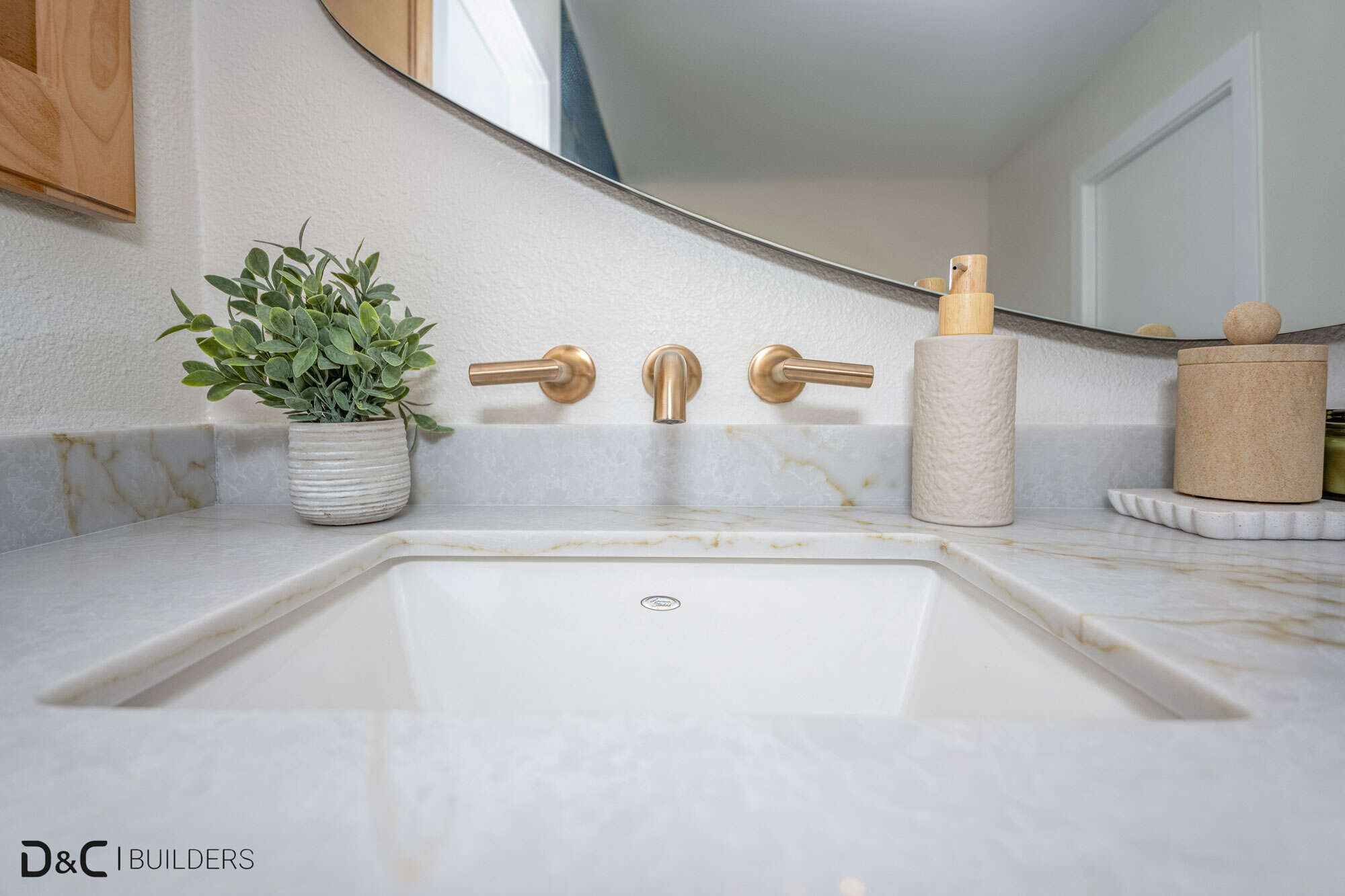 Sink with golden faucet and soap dispencer