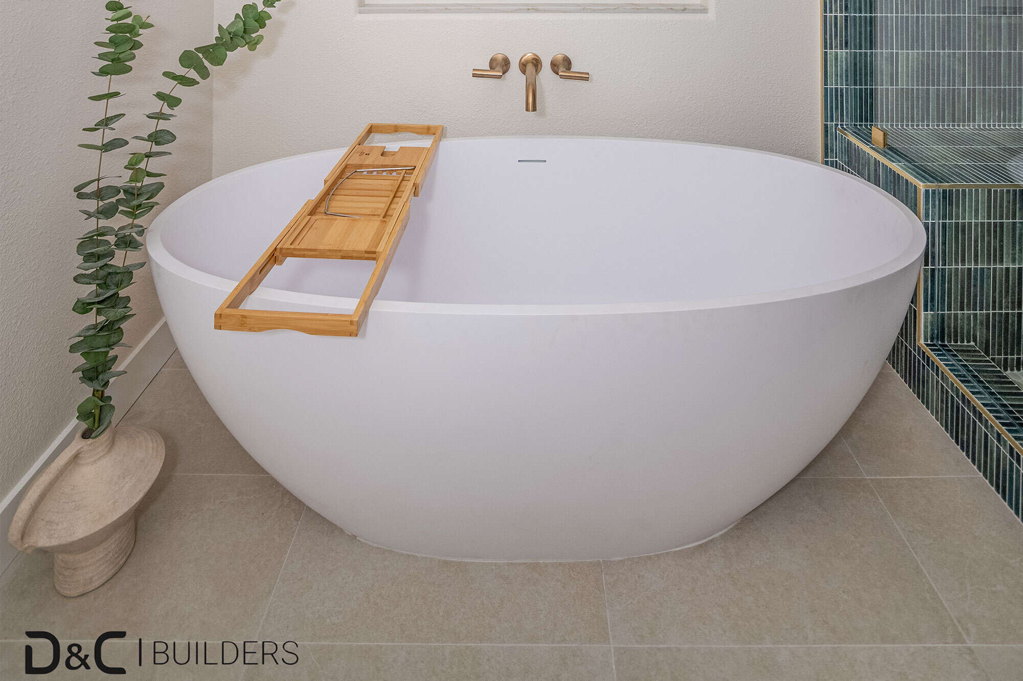 Bathtub in green-tiled bathroom