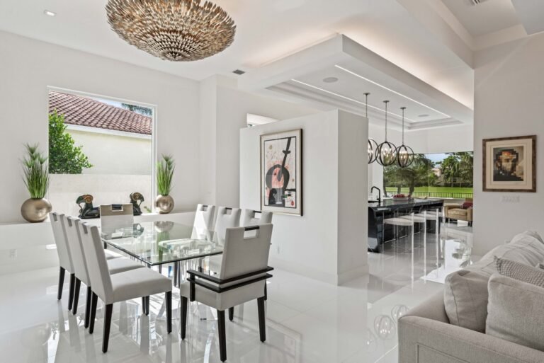 Modern dining room with glass table and custom ceiling design in Boca Raton home