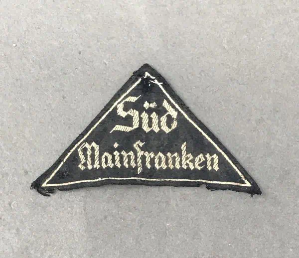 Süd Mainfranken patch with black background and white embroidered text.