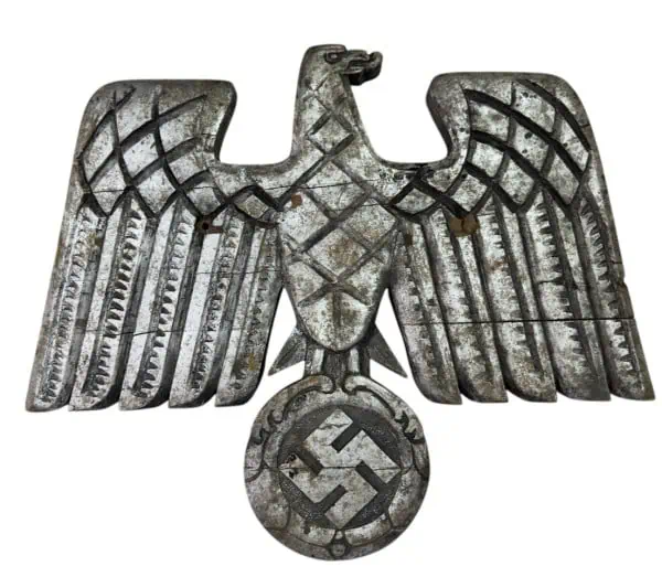 Metal eagle with swastika emblem, symbol of Nazi Germany, historical artifact.