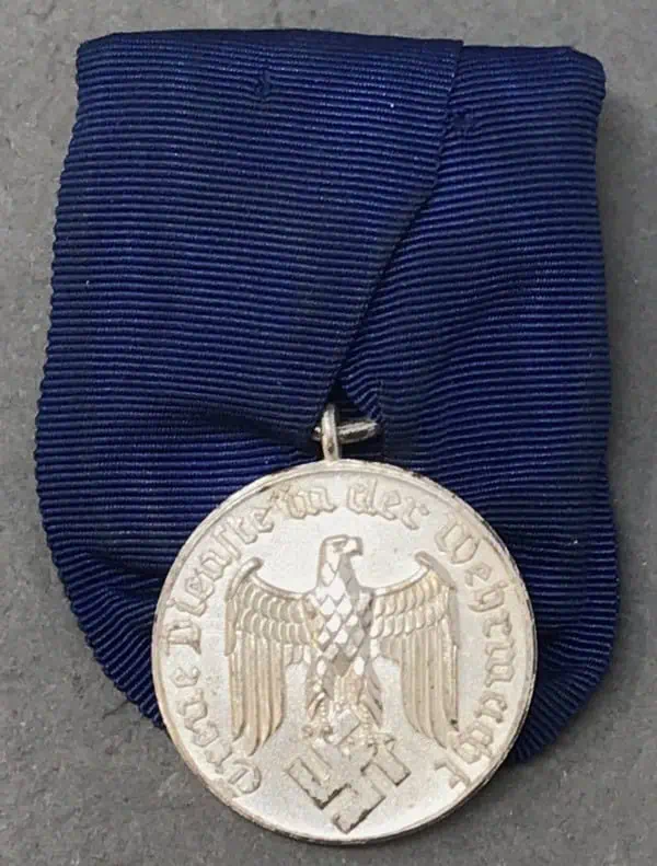 Civil War medal with eagle and swastika on blue ribbon.