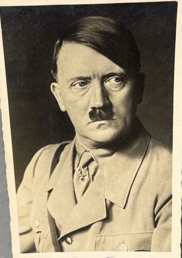 Historic black and white portrait of Adolf Hitler in military uniform.