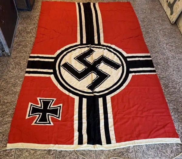 Swastika flag with black cross and iron cross symbol on red background.