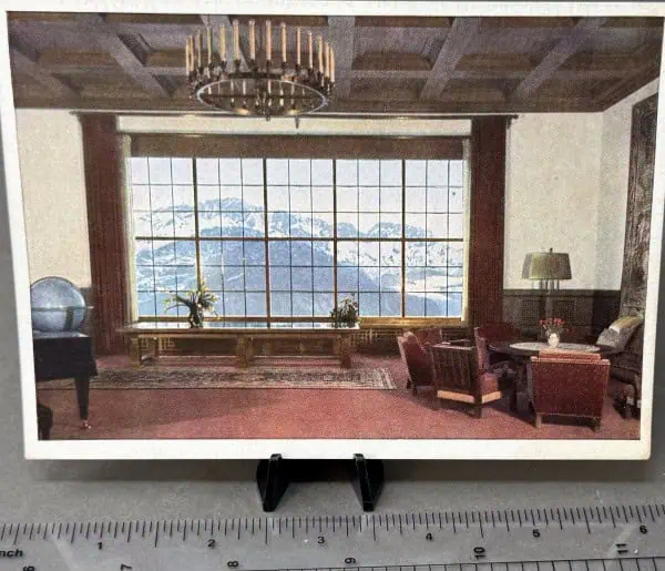 Elegant room with large window overlooking mountains and cozy seating area.