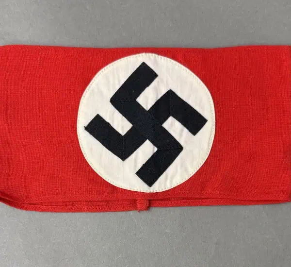 Swastika symbol on a red fabric banner, associated with historical Nazi imagery.