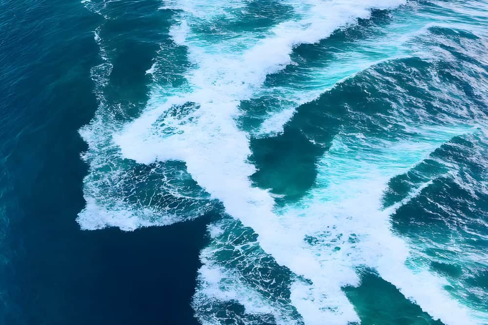 Vibrant ocean waves crashing, symbolizing dynamic media solutions and the power of media to create impactful change for brands.