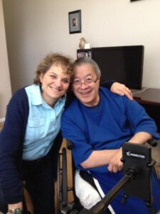 Smiling woman and man in a wheelchair sharing a joyful moment, representing Inclusion and Empowerment, with the logo of Difference Makers Media highlighting dedication to community engagement and positive storytelling.
