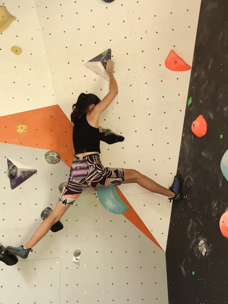 Climber bouldering at Randa Bouldering gym.