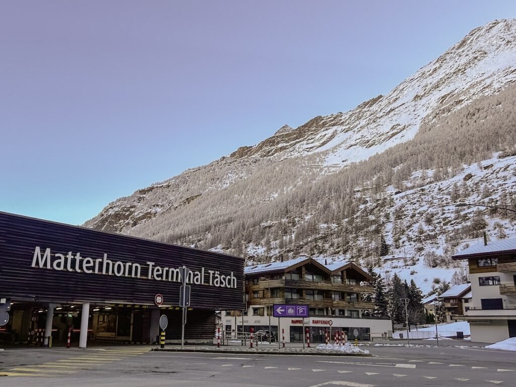 Parking garage in Täsch, Switzerland next to the snowy mountainside.