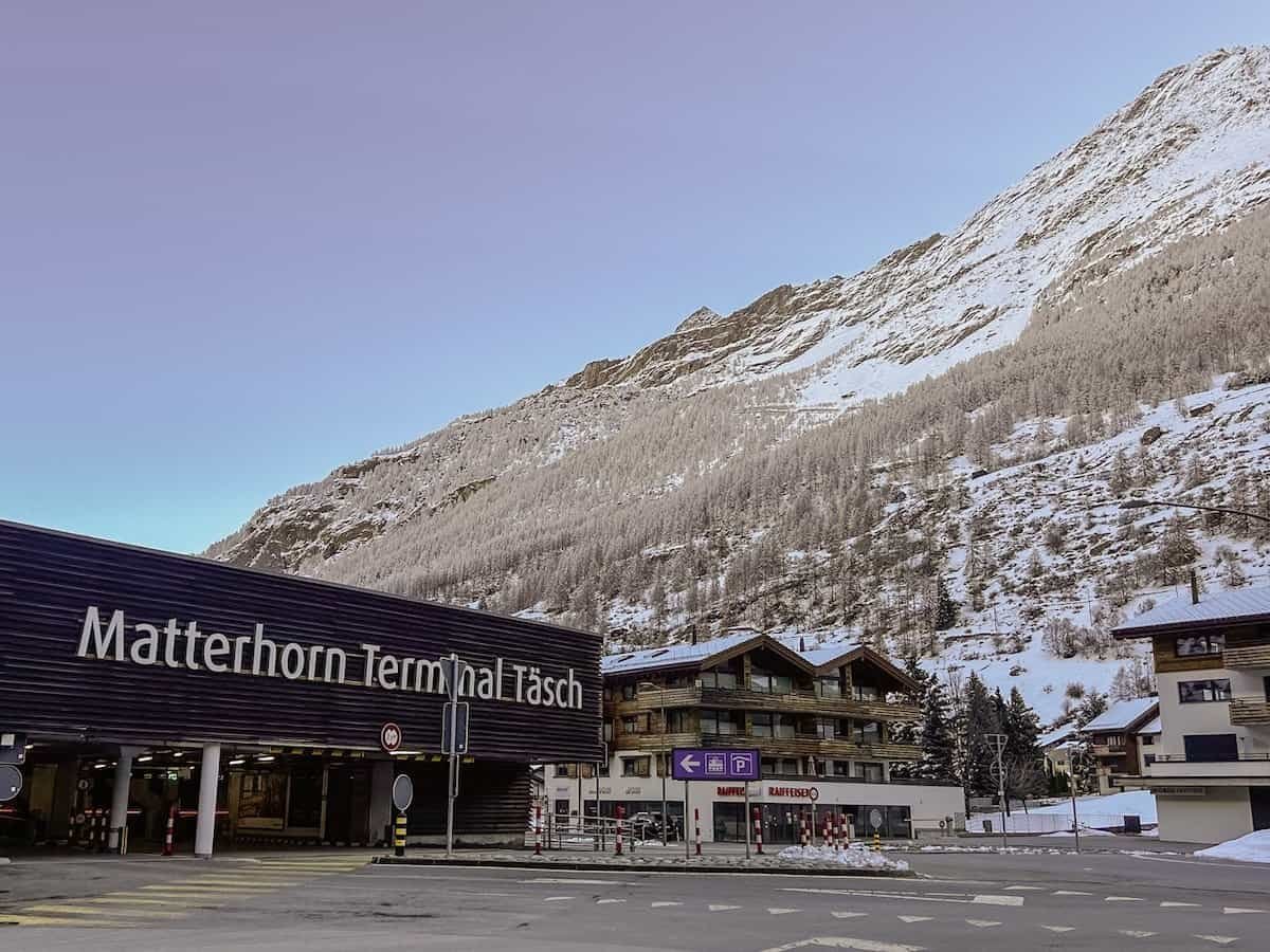 Parking garage in Täsch, Switzerland next to the snowy mountainside.