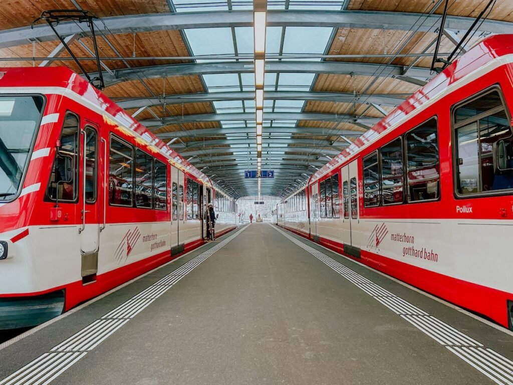Two Zermatt shuttle trains on the platforms at Täsch train station.