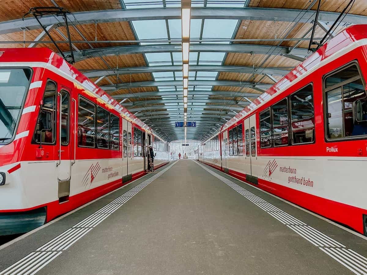 Two Zermatt shuttle trains on the platforms at Täsch train station.