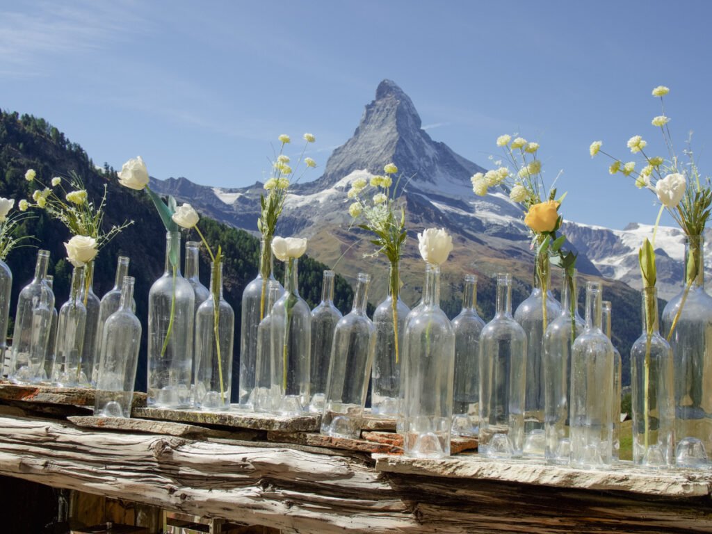 The Matterhorn and glass bottles with white and yellow flowers.