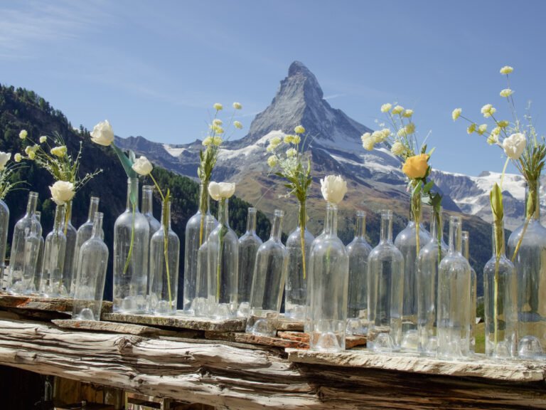 The Matterhorn and glass bottles with white and yellow flowers.