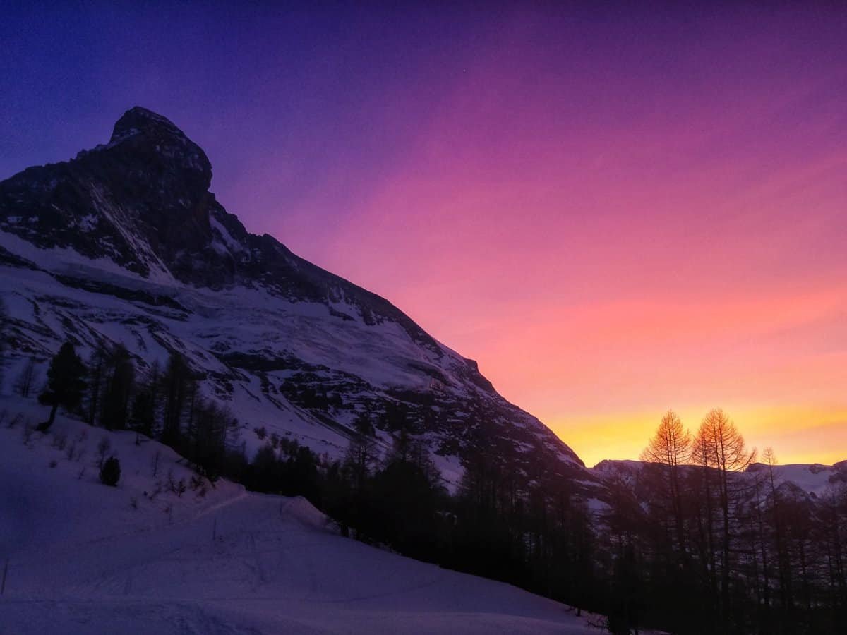 The north face of the Matterhorn at Sunset in pink, purple and orange.