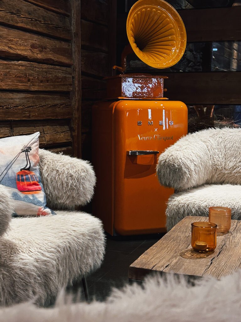 Fluffy seats and orange smeg fridge in the Loft Nightclub in Zermatt.