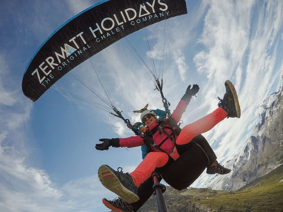 Tandem paragliders having fun above Zermatt.