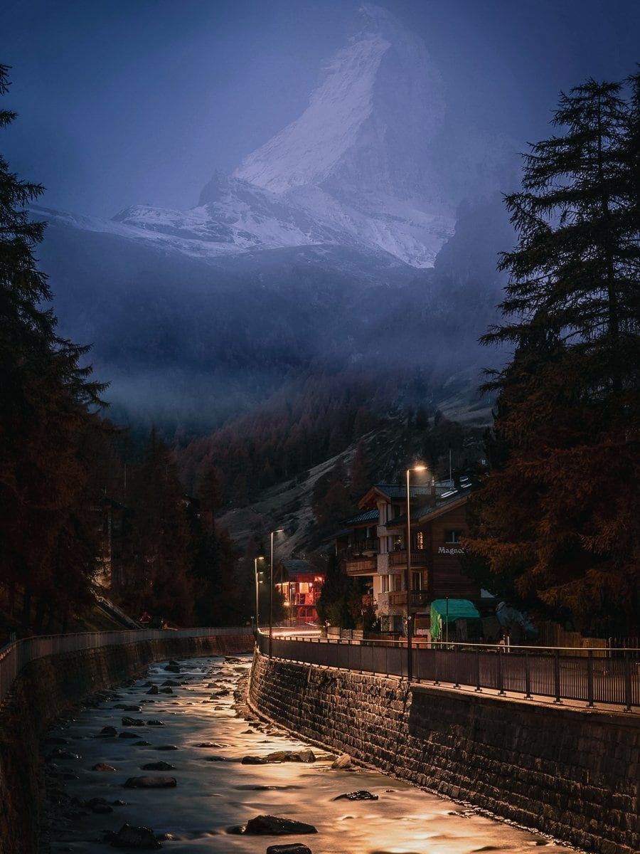 Misty Matterhorn and Zermatt river at night.