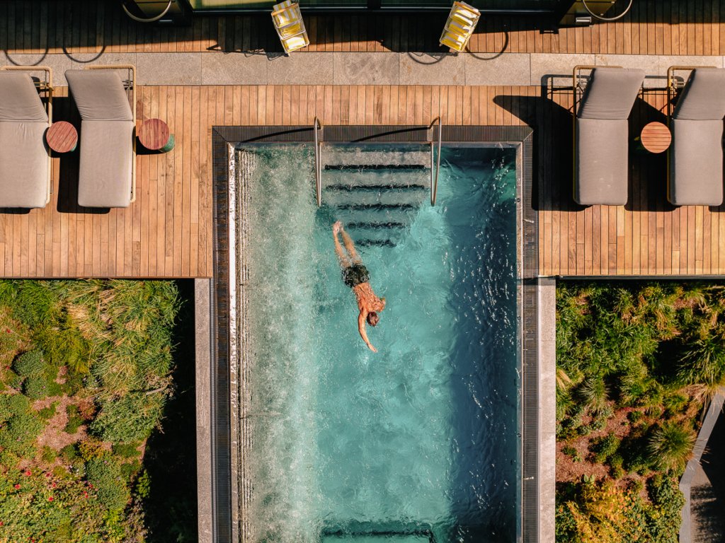 Person swimming in the pool at the Beausite, Zermatt.