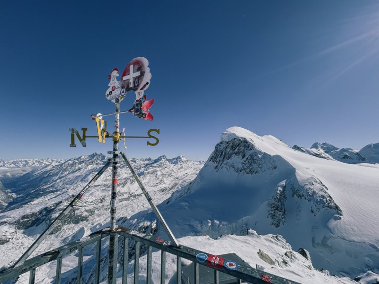 Compass and rooster sign on the viewing platform in front of the Breithorn in Switzerland.