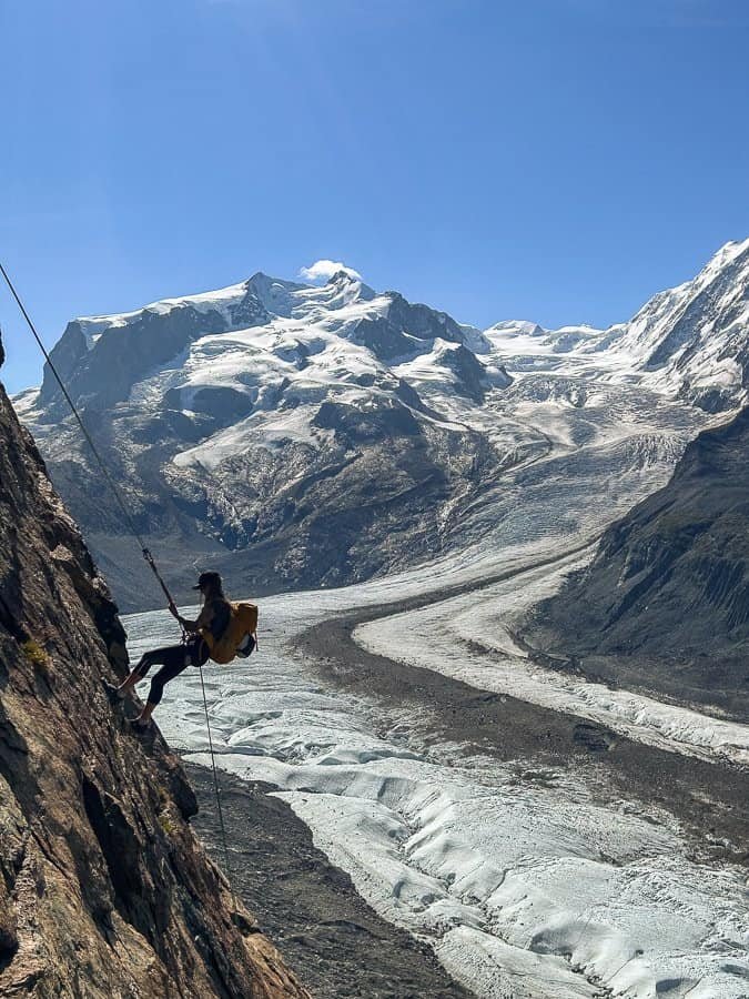 Rock climber in front of the Gorner Glacier in Zermatt.