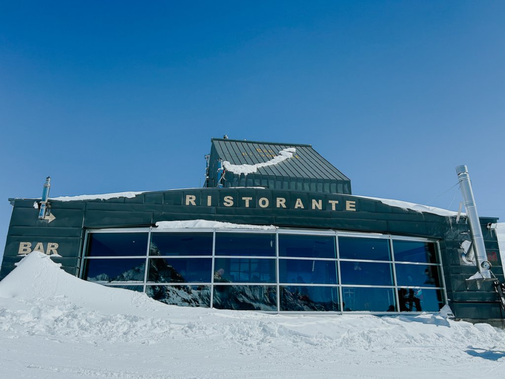 Snow and Restaurant Teodulo Cervinia on a sunny spring day.