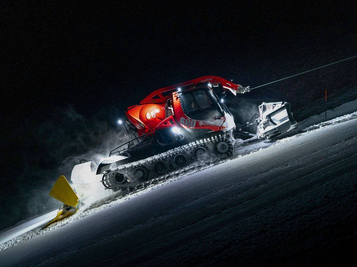 A piste basher, preparing the pistes at night in Zermatt, Switzerland.