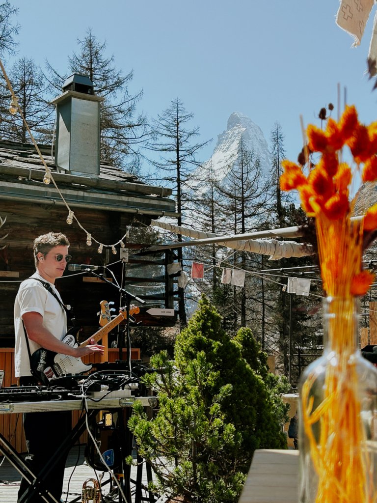 Musician and spring flowers at Cervo Zermatt.