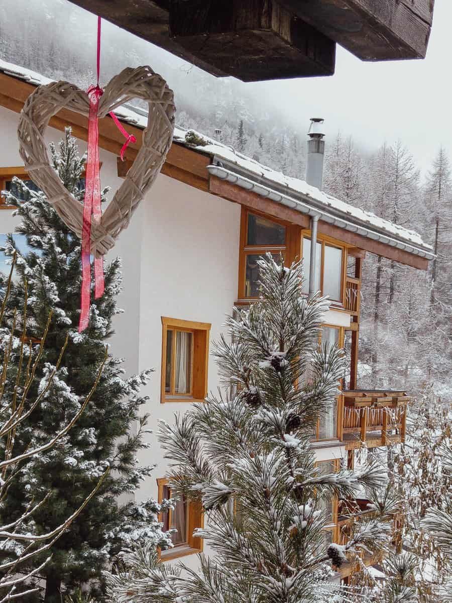Christmas decoration hanging iff a Swiss chalet.