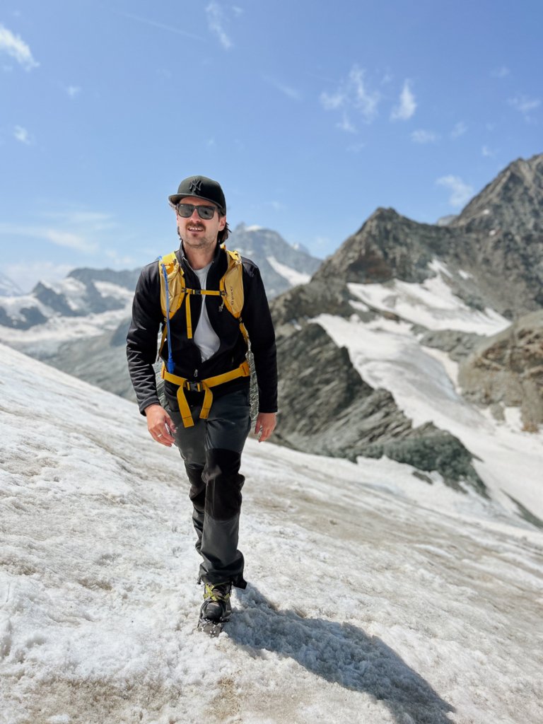 Man hiking across the glacier towards Mettelhorn in Zermatt, Switzerland.