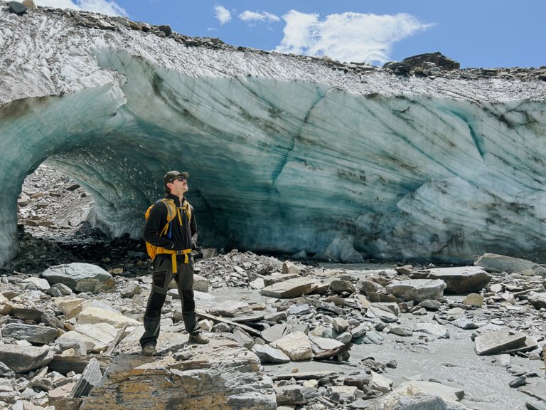 Man stood in front of a huge glacier in Zermatt, Switzerland.