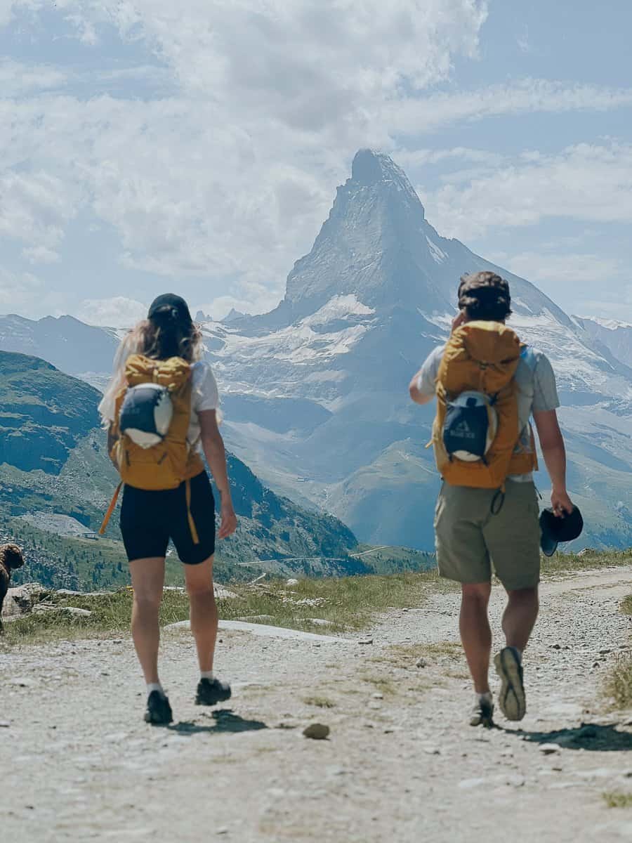 Couple walking in front of the Matterhorn in summer.