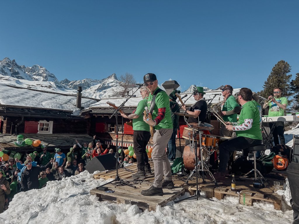 Musicians playing in green while celebrating St. Patricks day in Zermatt, Switzerland.