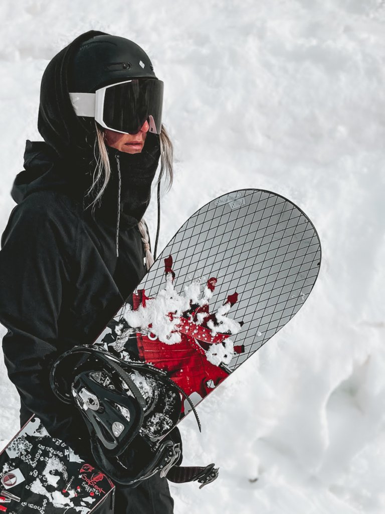 Snowboarder stood in front of a wall of snow in Zermatt.