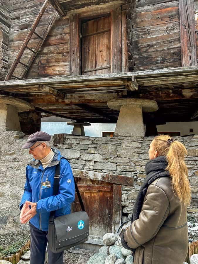 People in front of old Swiss mountain huts.
