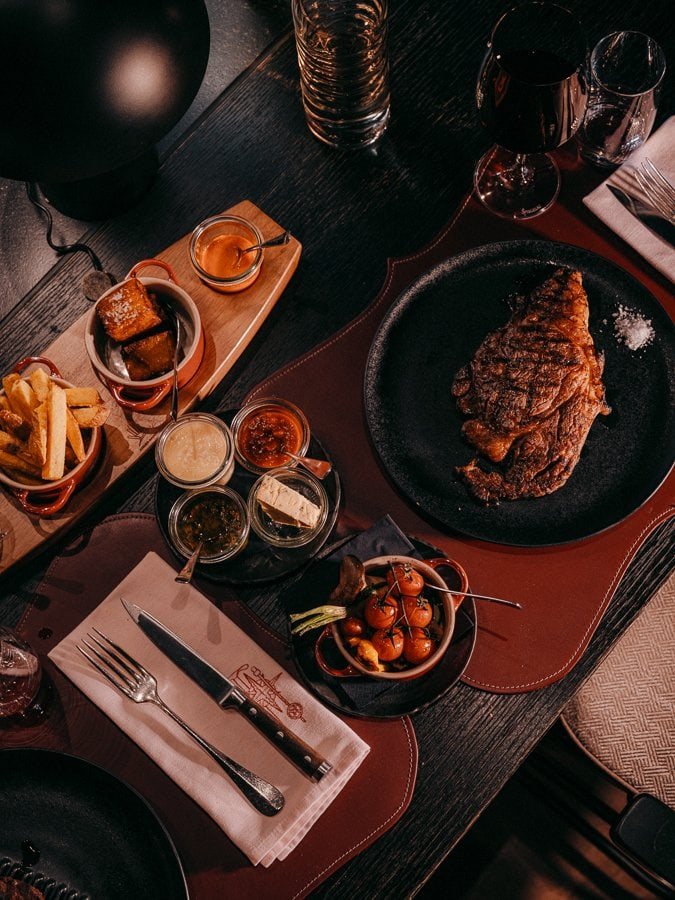 A steak and sides at The Grill, BEAUSiTE, one of Zermatt's best Grill restaurants.