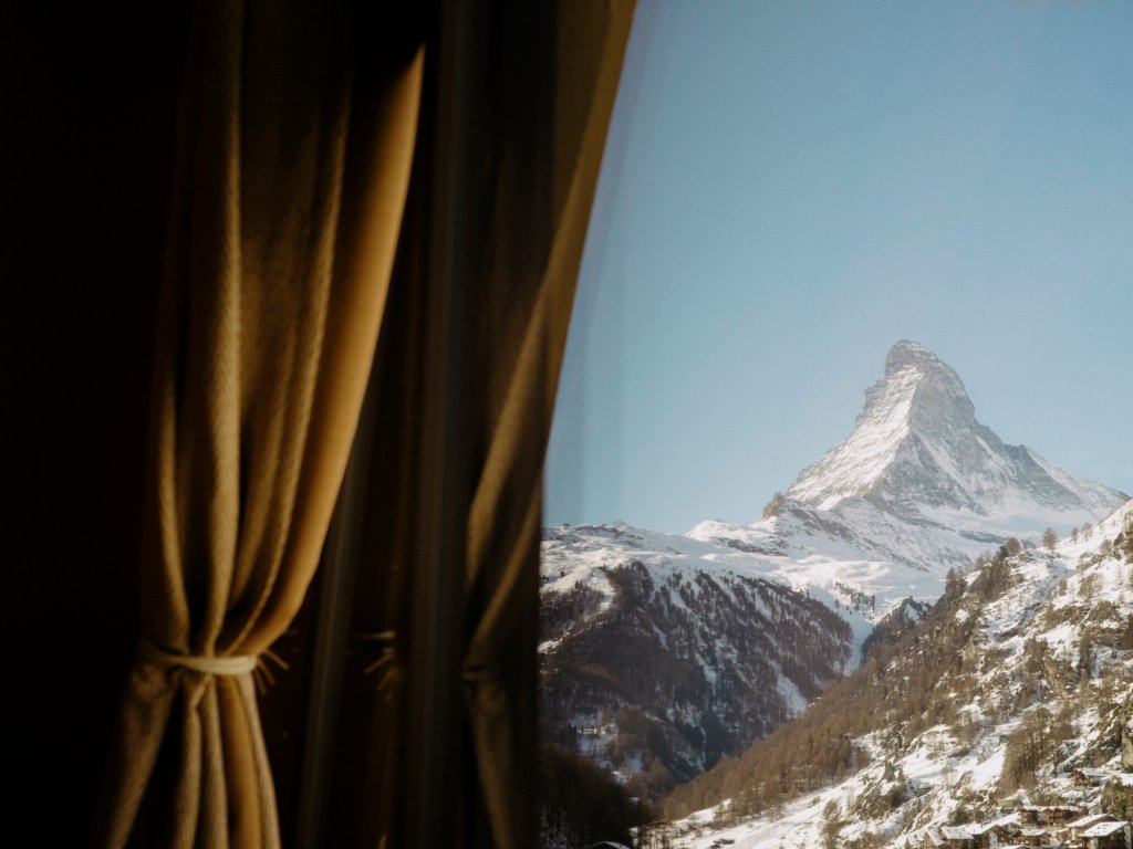 A snow covered Matterhorn in Zermatt, through the window of the Beausite Hotel.