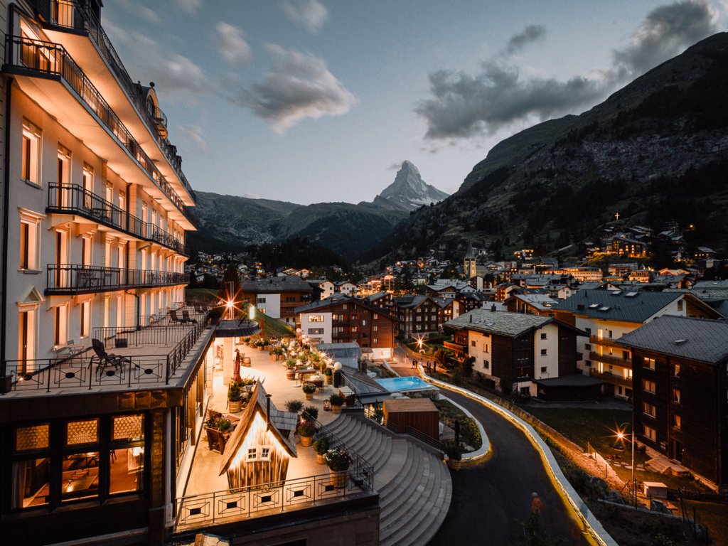 A view of Zermatt village and the Matterhorn at night from BEAUSiTE, where to stay in Zermatt for luxury.
