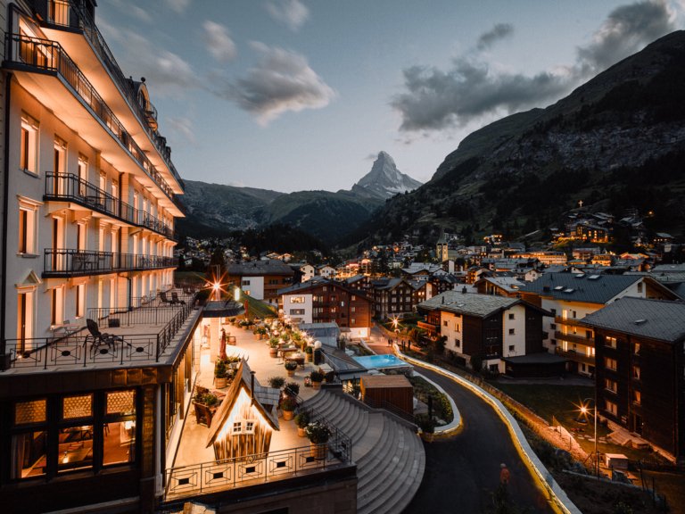 A view of Zermatt village and the Matterhorn at night from BEAUSiTE, where to stay in Zermatt for luxury.