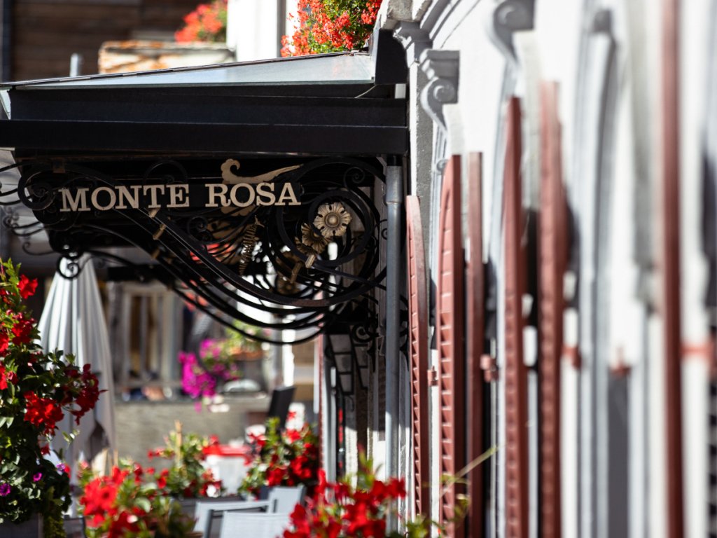 Shutters and metal signage of the Monte Rosa luxury hotel in Zermatt.