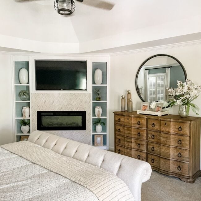 Bright living room featuring a stone fireplace, large windows, and modern furniture for a welcoming.