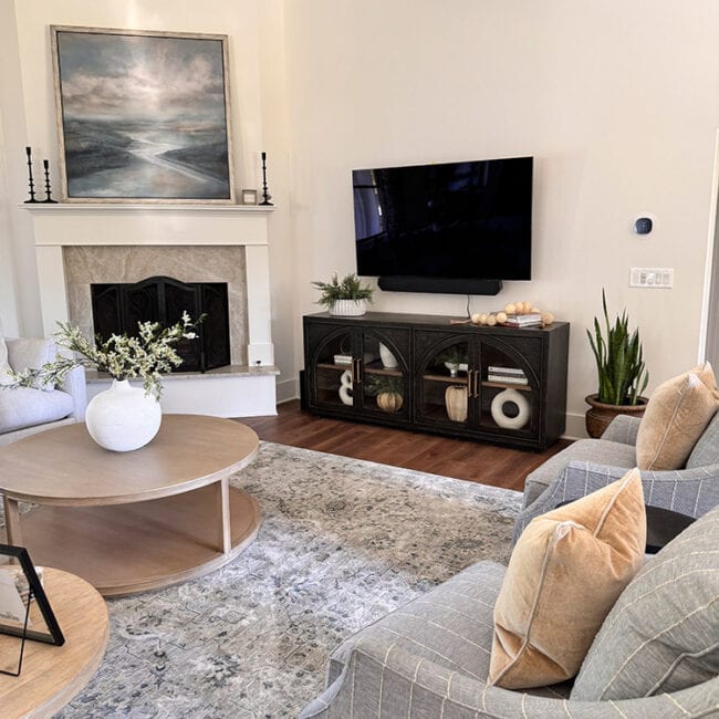 Contemporary living room with fireplace, flat-screen TV, and stylish decor.