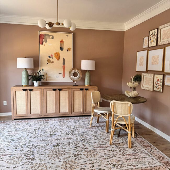 Stylish living room with abstract art, sideboard, and cozy seating area.