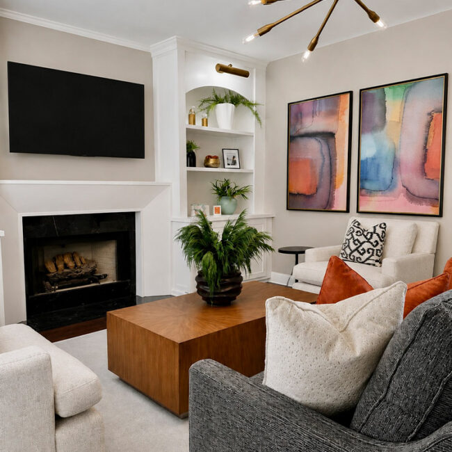Contemporary living room with fireplace, abstract art, and cozy seating.