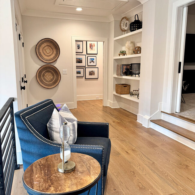 Comfortable living room with navy armchair and wooden side table.