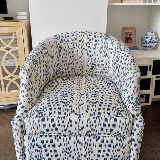Blue and white patterned armchair in cozy living space.