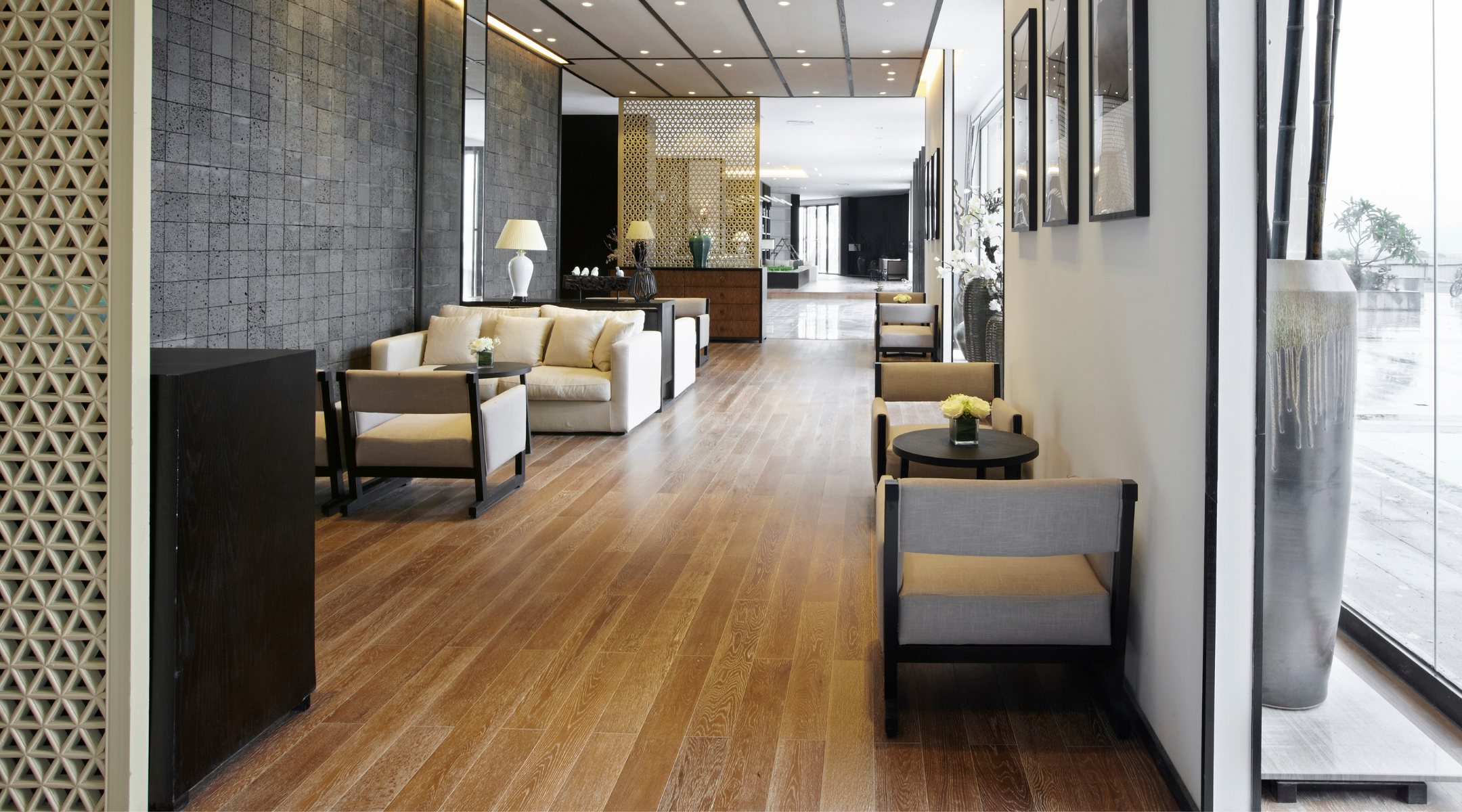 A room in a commercial office building with wood floors and tables and chairs. DPM Surface Care