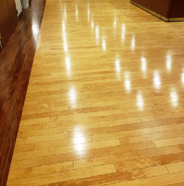A clean and shiny wood floors in commercial building hallway. DPM Surface Care