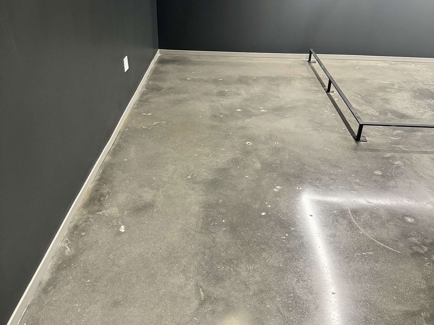 A cleaned concrete floor with water stain removed, after interior concrete floor cleaning. DPM Surface Care